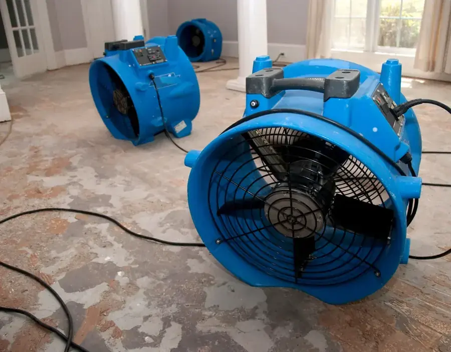 A high-volume air mover running on a floor in a Murrieta, CA home